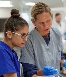 Dr. Heather Ross, newly appointed chair of the Brenau University Department of Physical Therapy, on right, helps doctorate of physical therapy student Kylie Beauchamp, left, in the department's human anatomy lab. (AJ Reynolds/Brenau University)