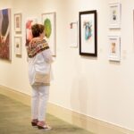 A patron takes in some of the artwork of Lyndrid Patterson during the reception.