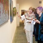 Sara Oakley, right, chats about some of her artwork during the reception.
