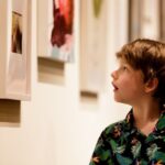 A young boy takes in some of the art on display during the President's Summer Art Series reception.