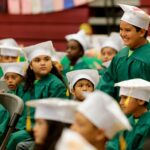 kids in graduation gowns sitting