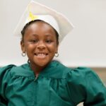 Child smiling in gown