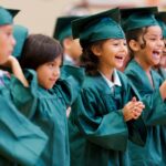 Abigail Gugliotta, center, cheers while a classmate dances during the graduation ceremony for the RISE summer program. (AJ Reynolds/Brenau University)