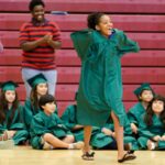 Paris Stafford walks to accept an award for perfect attendance during the graduation ceremony for the RISE summer program. (AJ Reynolds/Brenau University)