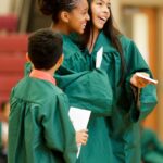 Paris Stafford and Josebeth Graciano hug after receiving awards for perfect attendance during the graduation ceremony for the RISE summer program. (AJ Reynolds/Brenau University)