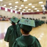 A student makes his way into the gym at Fair Street International Academy during the graduation ceremony for the RISE summer program. (AJ Reynolds/Brenau University)