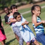 Students take part in a tug of war during the field day for the RISE summer program. (AJ Reynolds/Brenau University)