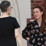 Anne talking with a faculty member outside