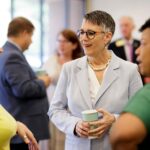 Anne Skleder talking with faculty at Norcross