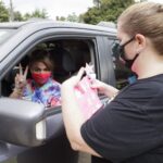 Maleah Boyd poses for a photo during a health screening as she goes through the drive thru check in process. (AJ Reynolds/Brenau University)