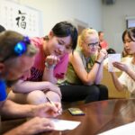 staff watches Chinese students write