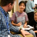 chinese student sitting with open book