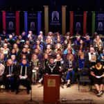 Faculty assembled on stage