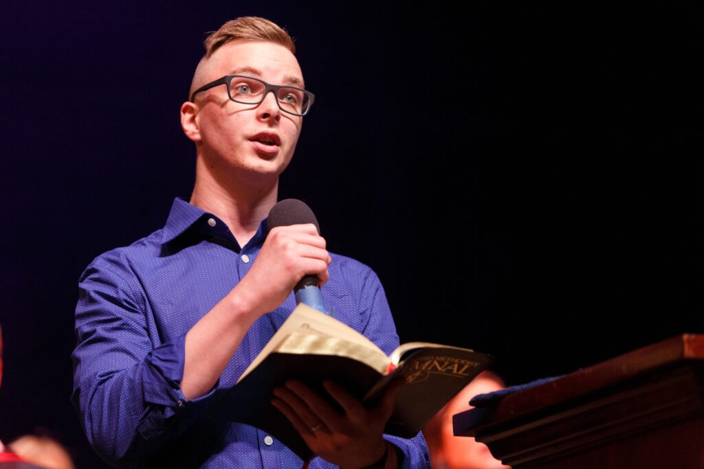 student reading from a book