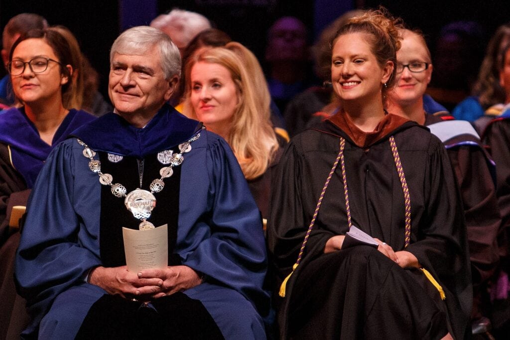 faculty sitting on stage