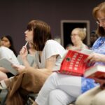 Audience member looking through book