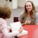 student sits with Jacquelyn Dowd Hall