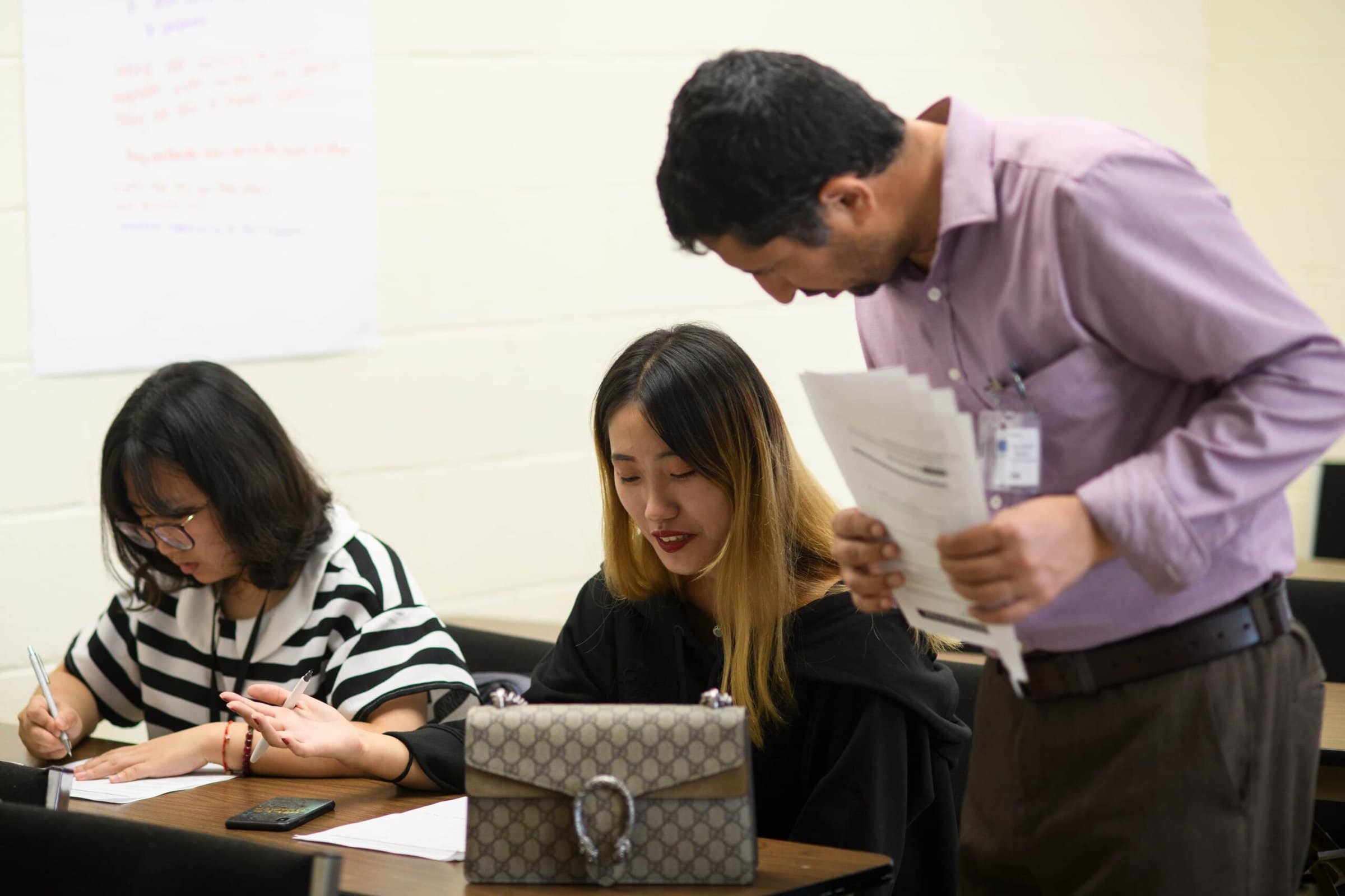 Khalid Ibrahim, President of ON Language, explains an assignment to Xu "Lexy" Ying, left, and Zhou "Sylvia" Yu, education majors from Brenau's 2+2 program with Anhui Normal University, during an ON Language class at Brenau University. (AJ Reynolds/Brenau University)