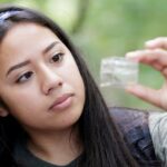 Students looks at water sample