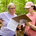 Karen Henman and a student discuss results at Chicopee Lake.