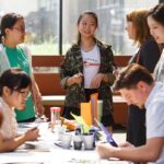 From left to right Tanwenqing "Ashley" He, Haiyan "Hedy" Yin, Emily Zank, associate provost, and Yongyi "Eva" Ni take part in an activity during LitFest at the Brenau University Downtown Center. (AJ Reynolds/Brenau University)