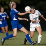 A soccer player heads the ball.