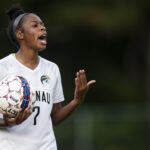 A soccer player calls out to her teammates.