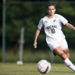 a student charges the soccer ball