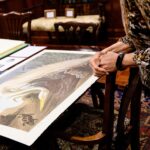 A guest views a print from the Amsterdam edition of Audubon's "Birds of America"