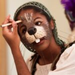 Student putting on Beaver makeup