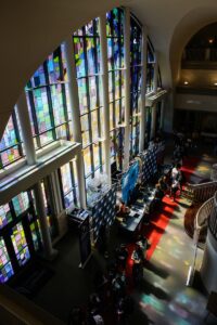 A line of students in the atrium of the John S. Burd Center for the Performing Arts.