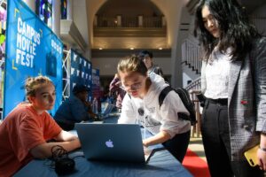 Students sign up for Campus Movie Fest on a laptop