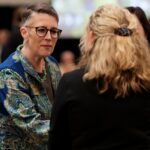 President Anne Skleder speaks with people at the induction ceremony.