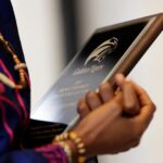 Esther Anyanwu holds her plaque.