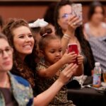 Family members watch the induction.