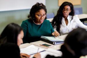 students at desks with papers during mock mediation tournament