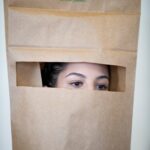 A student with a paper bag