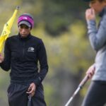 Brenau's Niquole Mangal holding golf flag