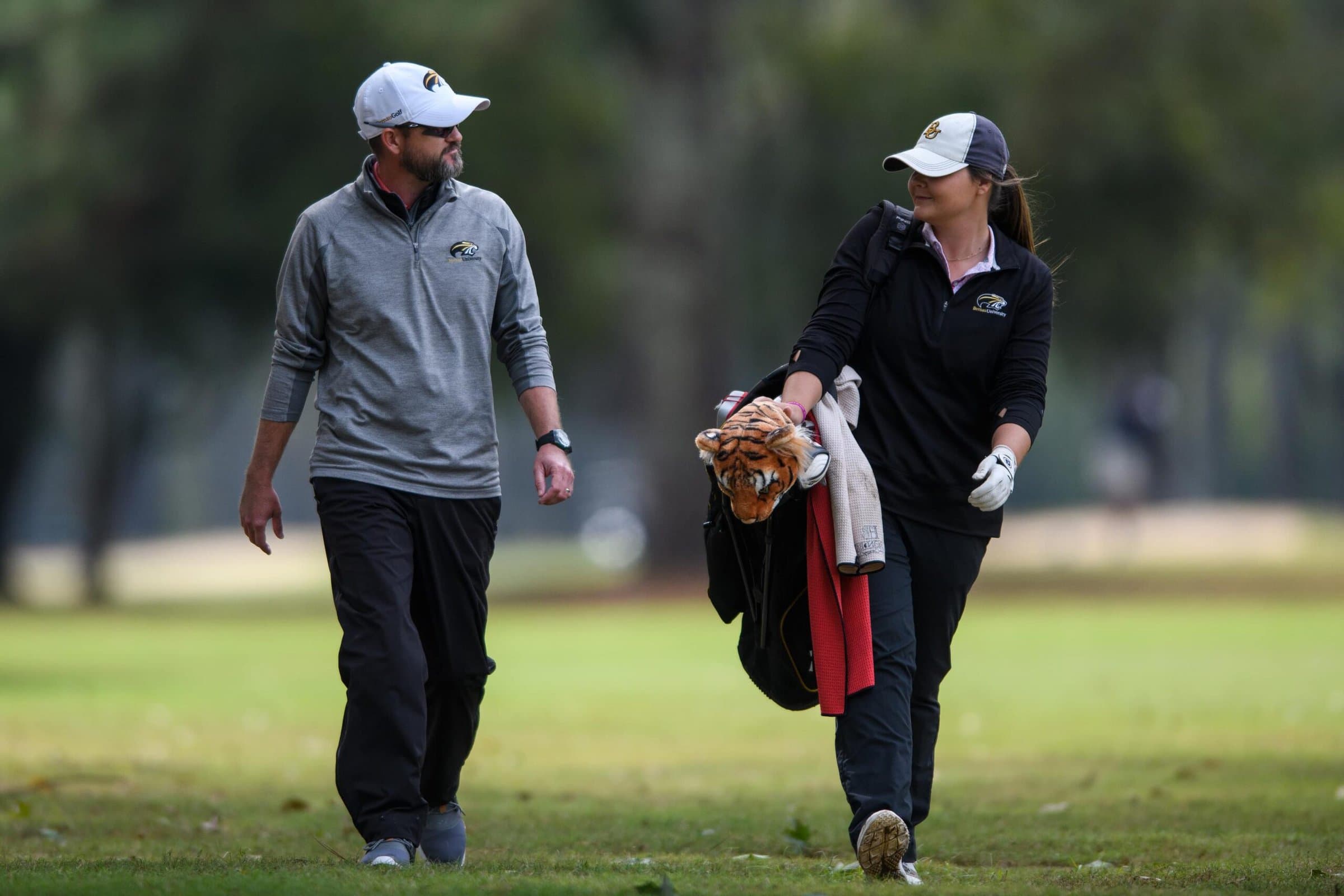 Brenau head coach Damon Stancil and Brenau's Macie Hurst walking and talking