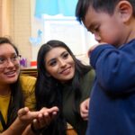 two students talking with a kid