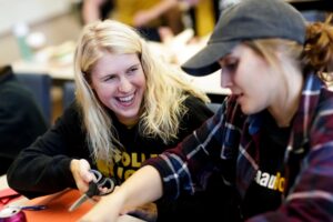 Maddie Thomas, left, hands a pair of scissors to Carleigh Mize.