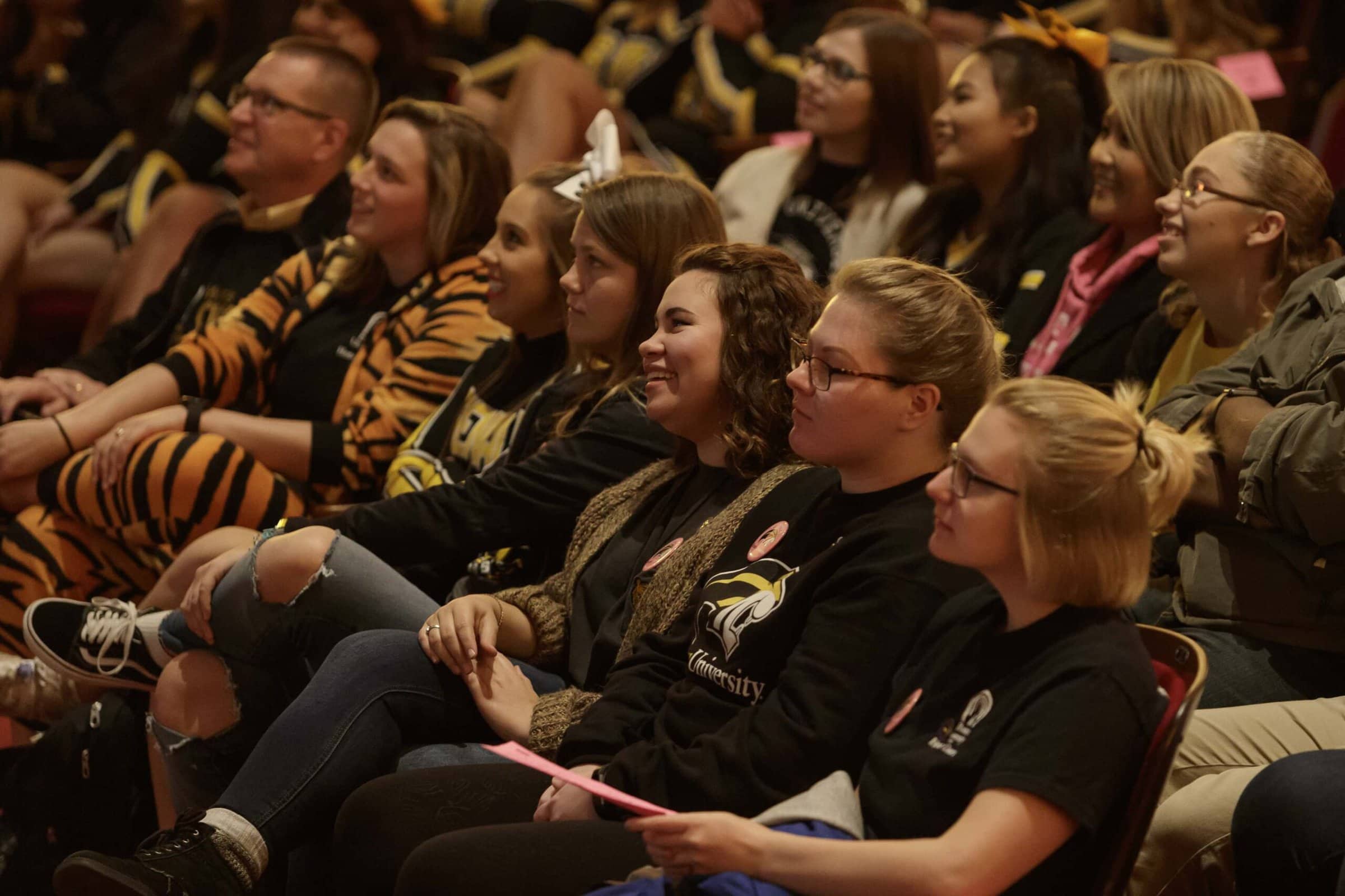 Students settle in and listen to speakers.