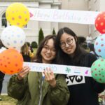 Students taking photos with decorated frame.