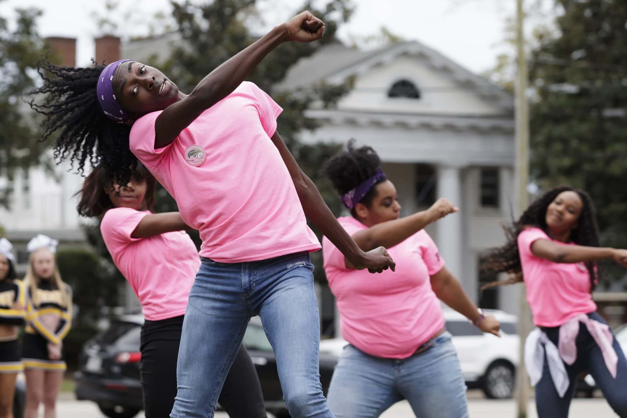 Students perform dance following speakers. 