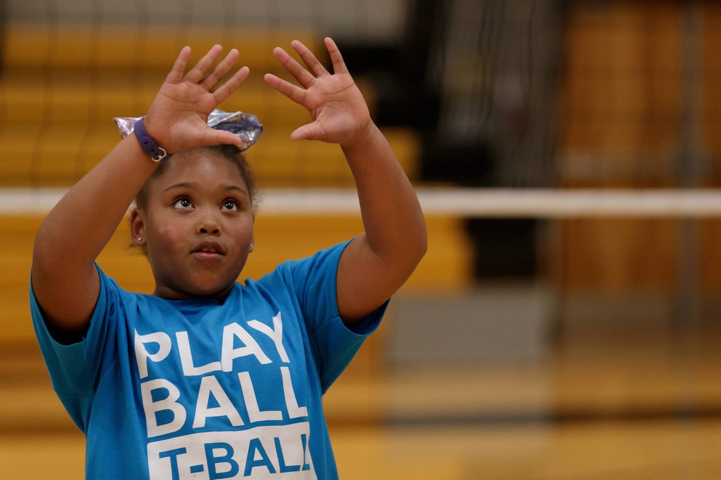 Youth girl playing volleyball in gym, focusing on ball, active sports, college sports, Brenau University.