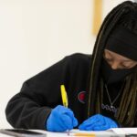Female student making a GOLDen gram