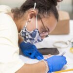student drawing on a golden gram