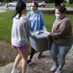 more student carying food for the food drive
