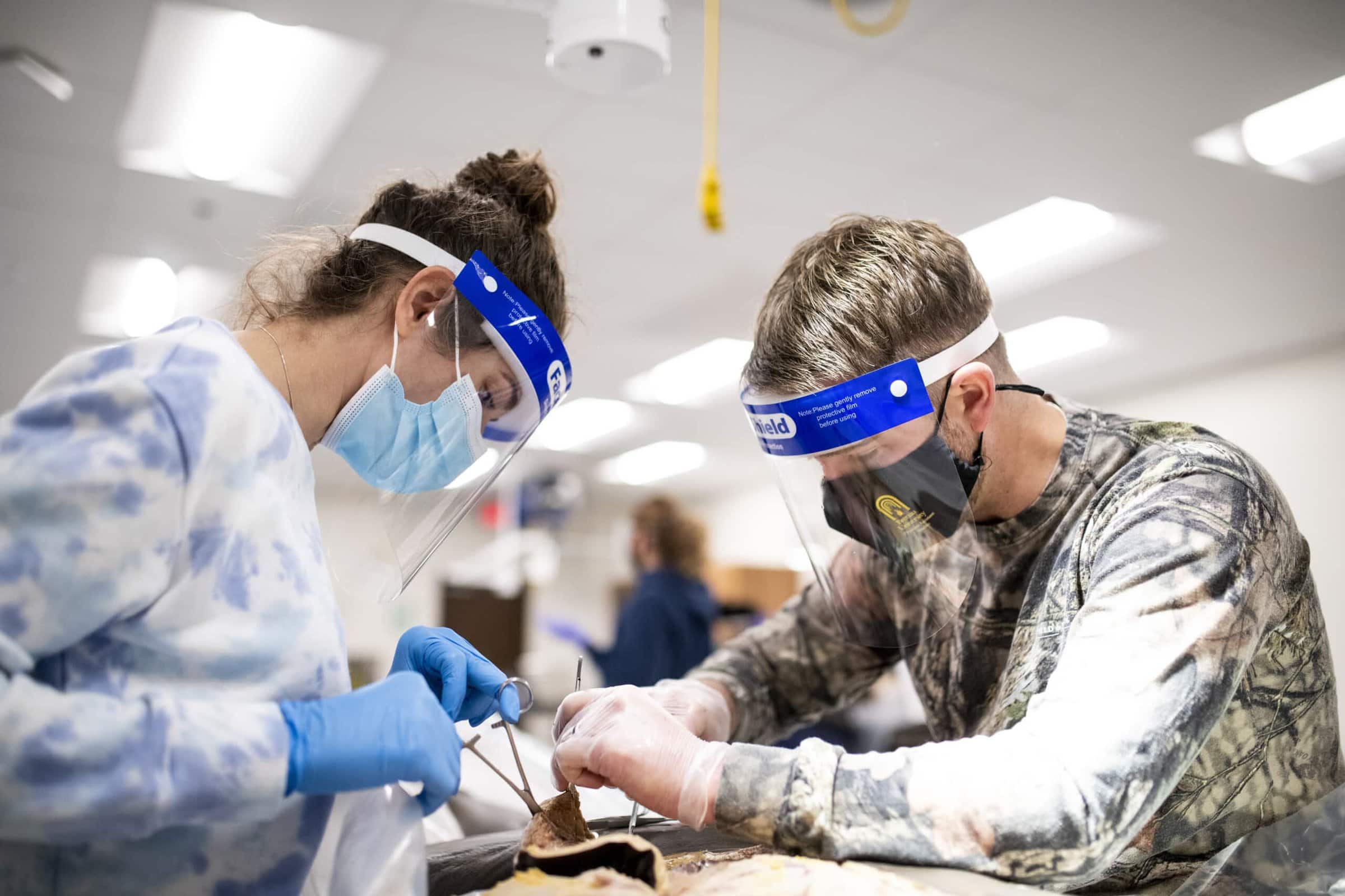 two Physician Assistant Studies students participate in their first lab.