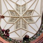 Karen Baker, Morgan Davis and Dominique Wagner decorate the grand staircase at the Callanwolde Fine Arts Center in Atlanta on Tuesday, Nov. 20, 2018. (AJ Reynolds/Brenau University)